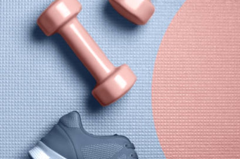 Mellow rose color dumbbells and Skyway color sneakers on the mat flat lay. Design for poster or banner. - Image